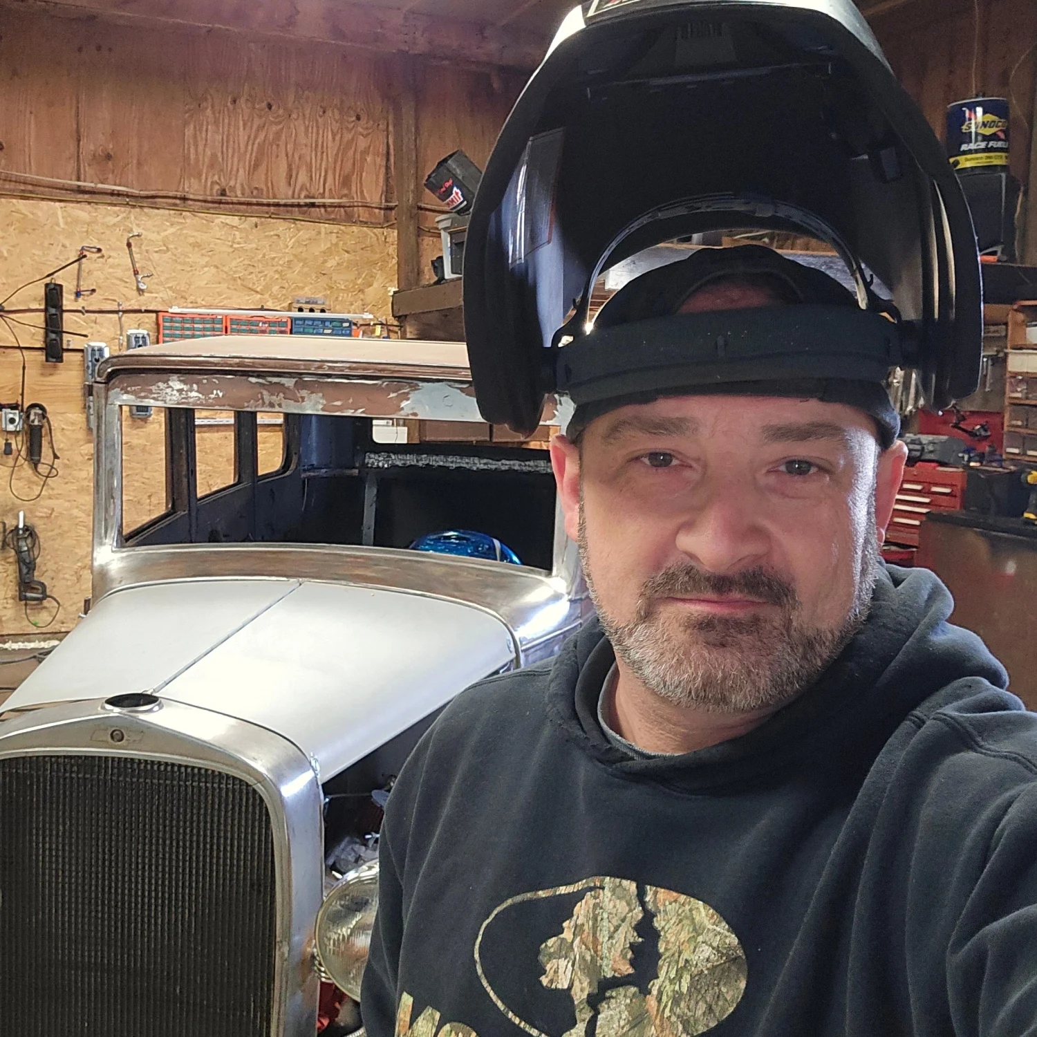 IMG_20250324_073119_384 Man with welding helmet in garage.