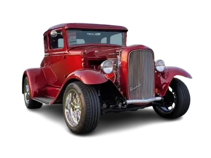 A red car is parked in the dark.